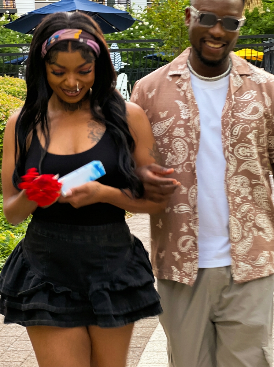 Two friends arriving at an outdoor gathering with a fragrance gift